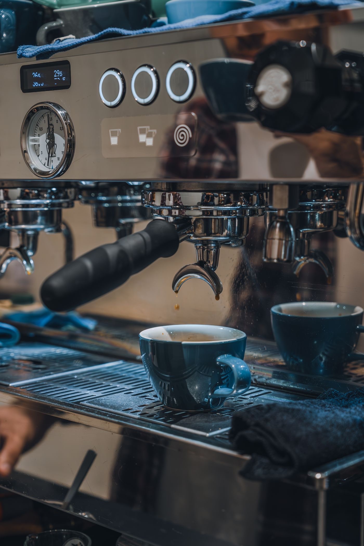 Commercial espresso machine in use in a café